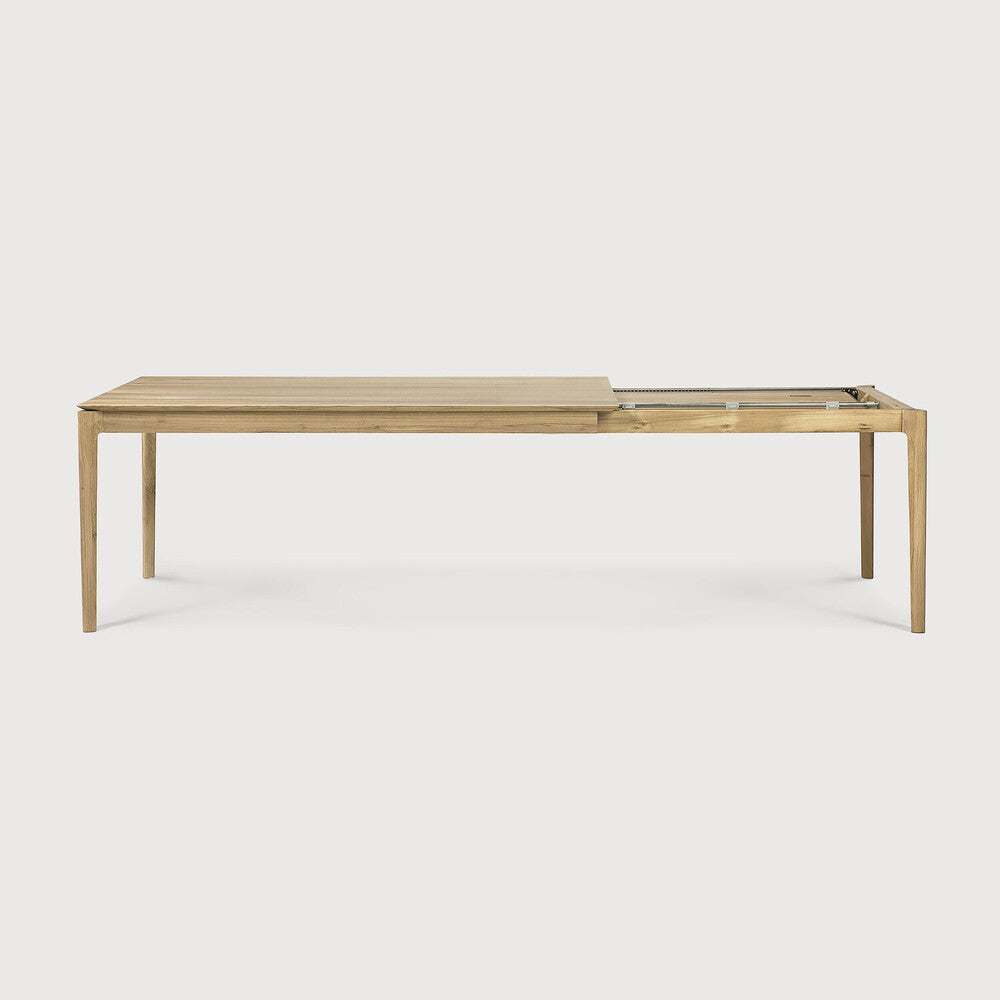 Table à manger extensible contemporaine en chêne massif avec plateau rectangulaire et piètement ajouré pour salle à manger