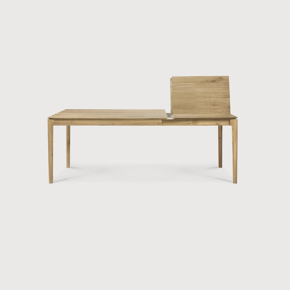 Table à manger extensible contemporaine en chêne massif avec plateau rectangulaire et piètement ajouré pour salle à manger