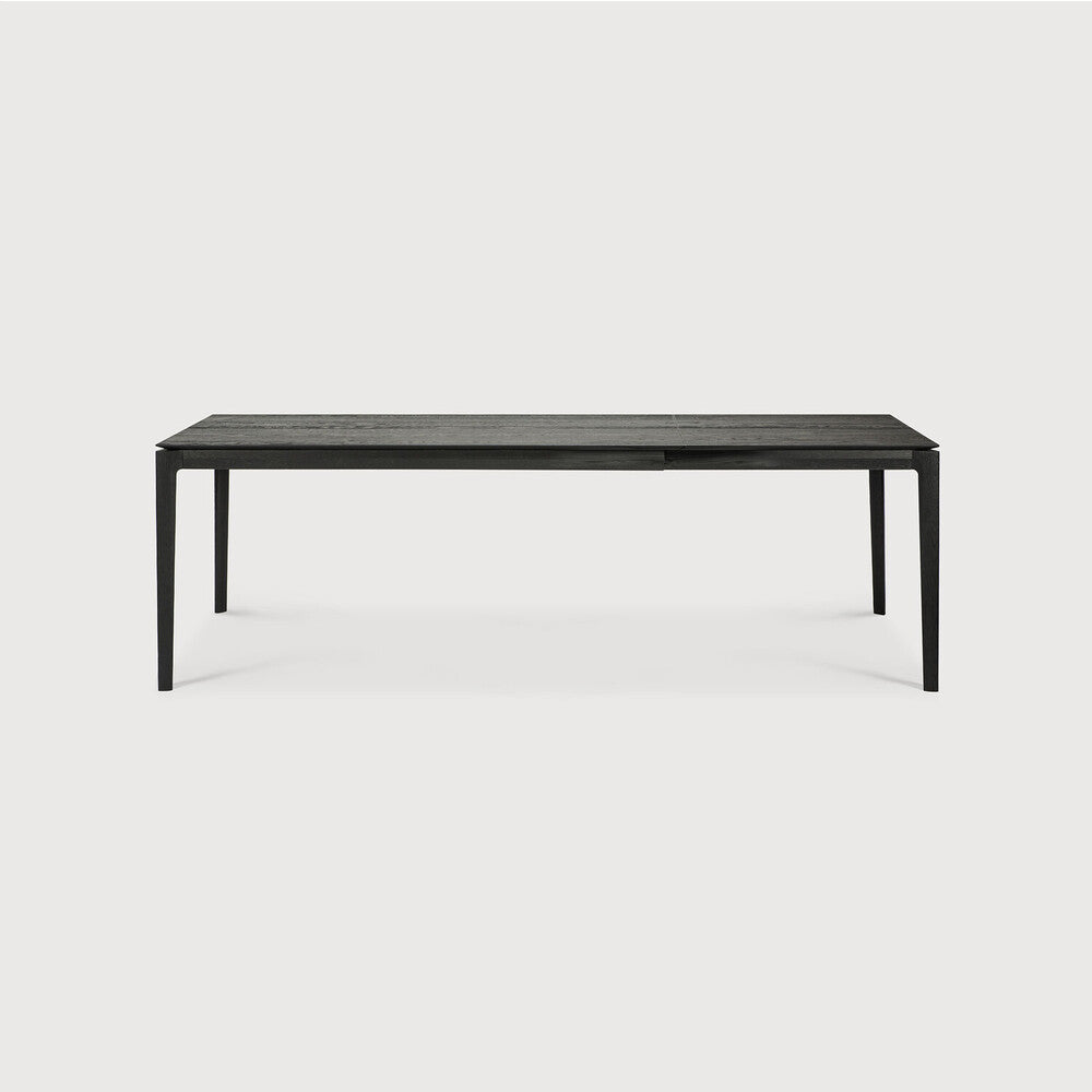 Table à manger extensible contemporaine en chêne massif avec plateau rectangulaire et piètement ajouré pour salle à manger