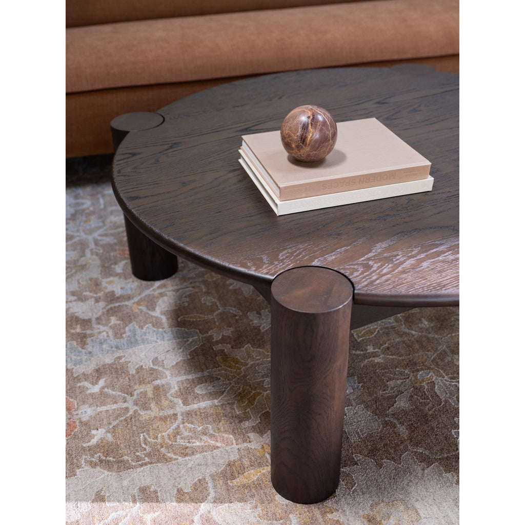 Table basse organique moderne en chêne massif avec plateau rond à bord arrondi et pieds colonne pour salon