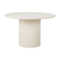 Table de salle à manger artisanale en micro-ciment avec plateau rond texturé effet pierre naturelle