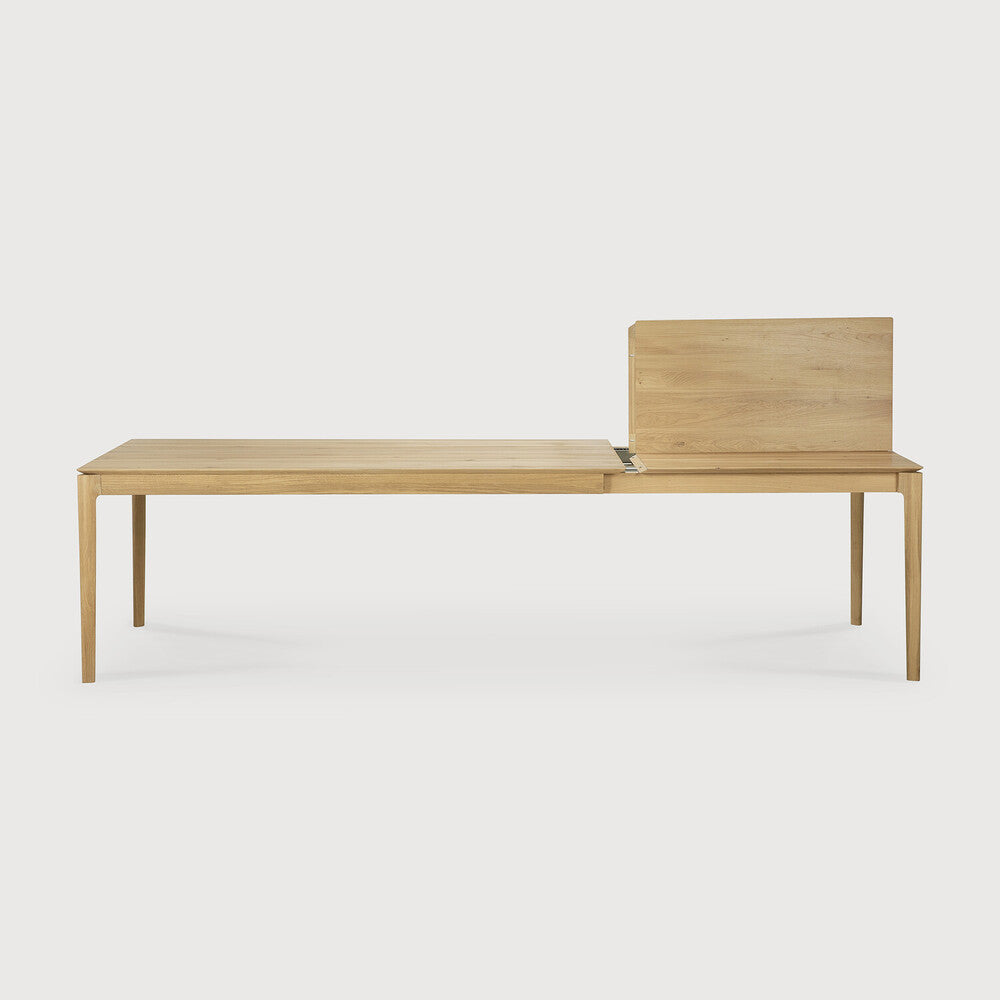 Table à manger extensible contemporaine en chêne massif avec plateau rectangulaire et piètement ajouré pour salle à manger