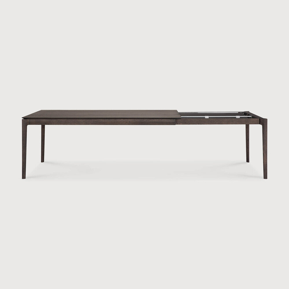 Table à manger extensible contemporaine en chêne massif avec plateau rectangulaire et piètement ajouré pour salle à manger