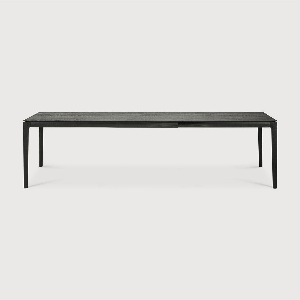 Table à manger extensible contemporaine en chêne massif avec plateau rectangulaire et piètement ajouré pour salle à manger