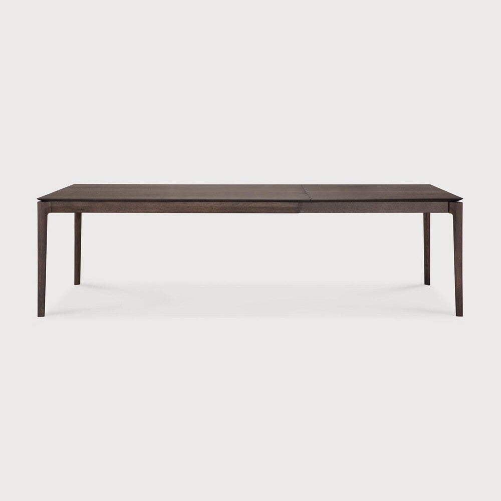 Table à manger extensible contemporaine en chêne massif avec plateau rectangulaire et piètement ajouré pour salle à manger